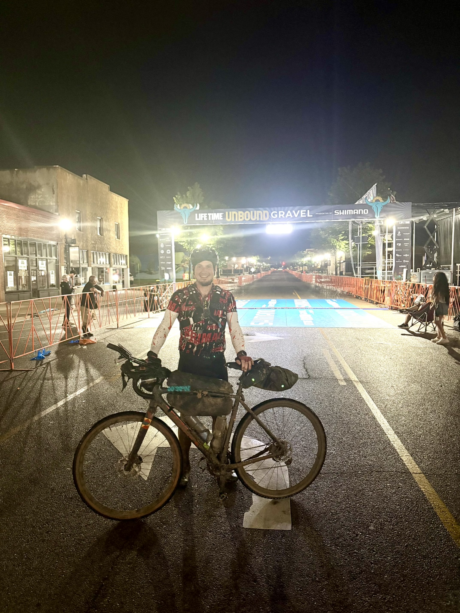Brady with his mud-covered bicycle at the Unbound XL finish