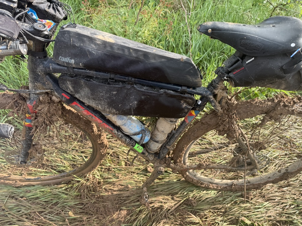 Mud packed around the bicycle after walking through Unbound XL conditions